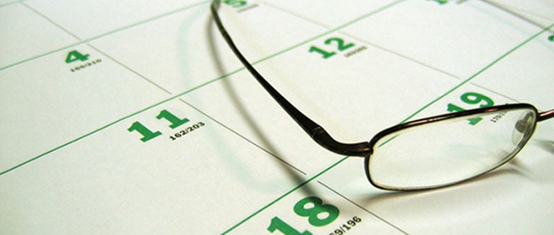 Glasses resting on a calendar.